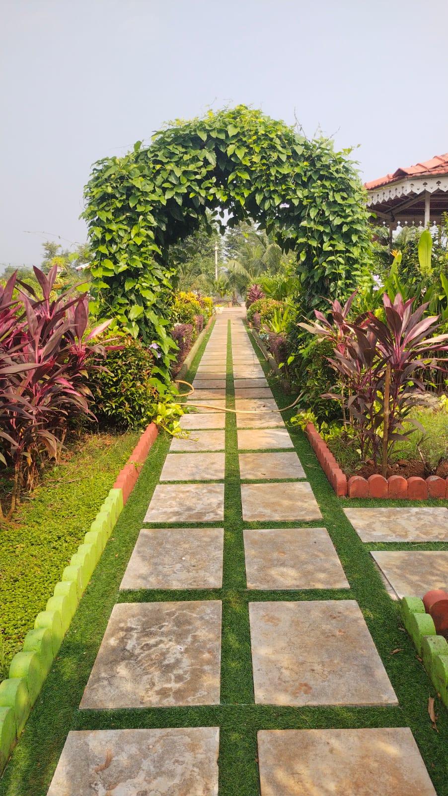 Beautifully designed garden pathway with decorative arch by Aditya Enterprises
